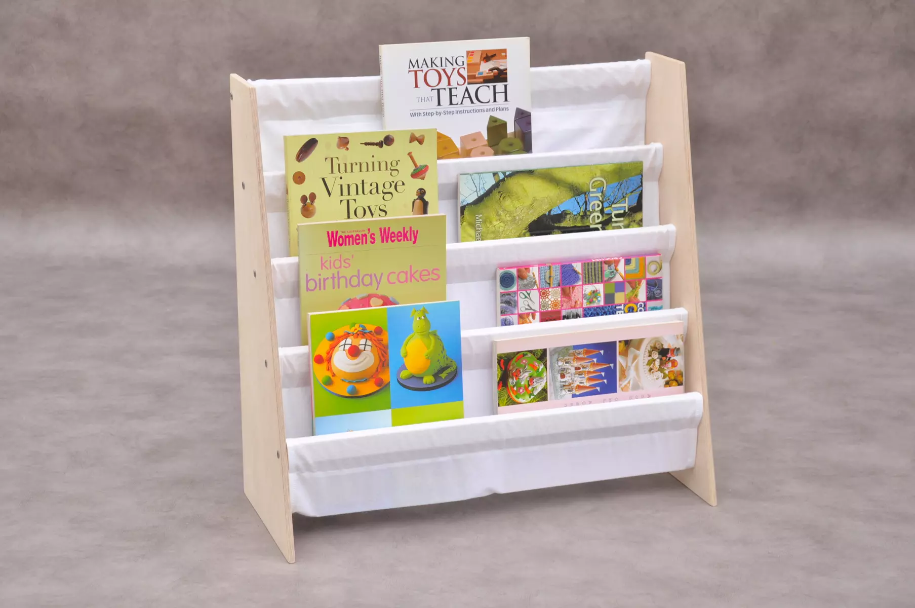 Children's sling bookcase Montessori front facing bookshelf for nursery and kid's play rooms with 4 tier white cotton fabric display shelves by Barin Toys uk toyshop available online.
